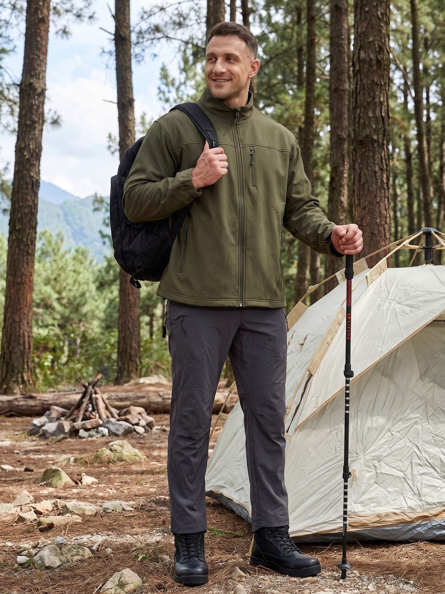 Army green TACVASEN fleece-lined softshell jacket worn outdoors with chest zipper pocket visible