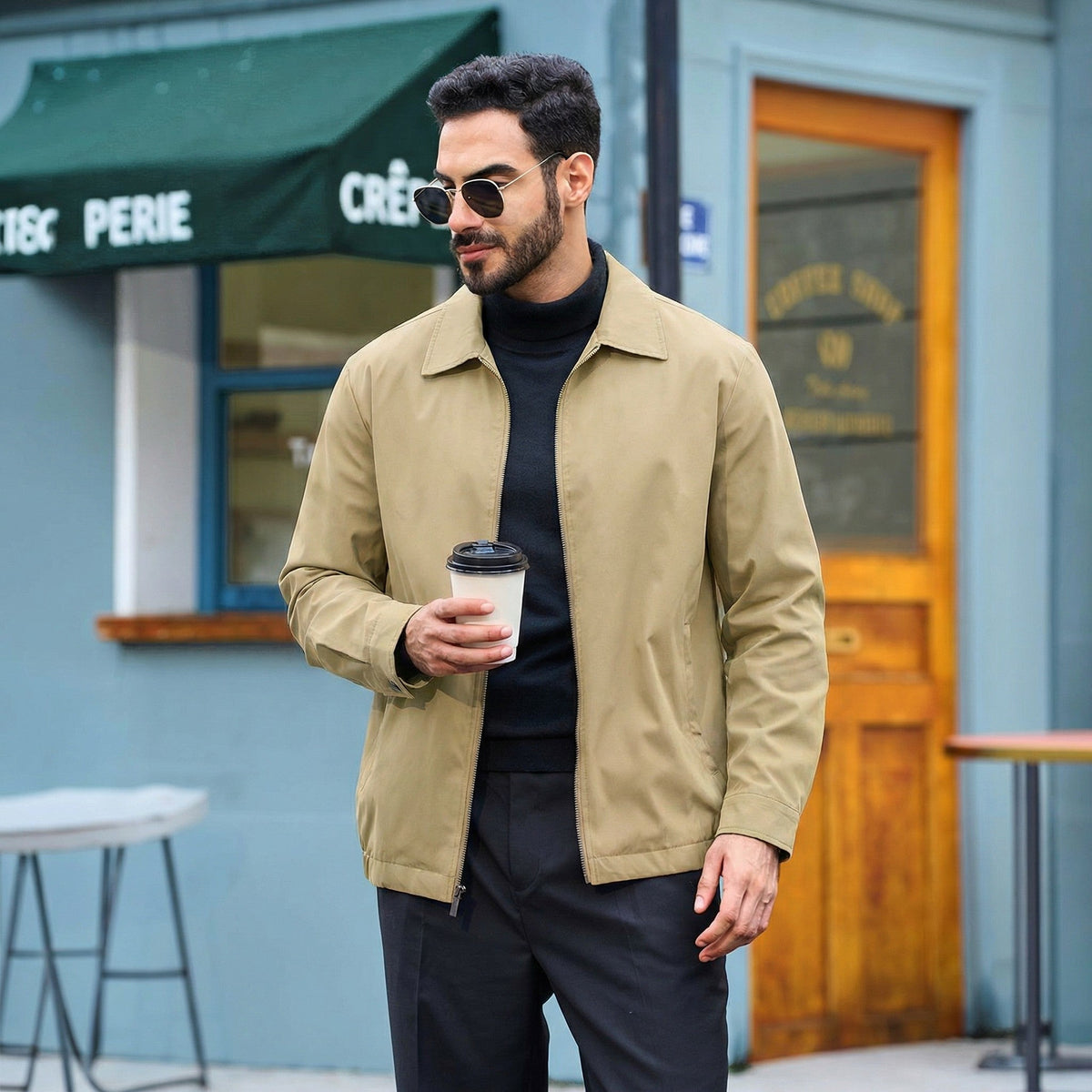 Man wearing a khaki TACVASEN lightweight spring work jacket over a black layer in the city